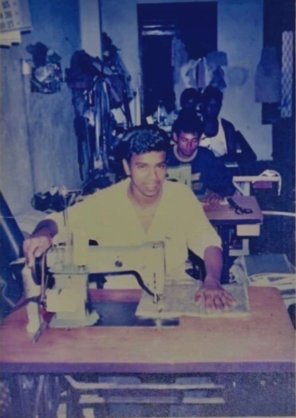 Mr. Nilantha Edirisinghe at a sewing machine, learning to sew cushions in the late 1990s